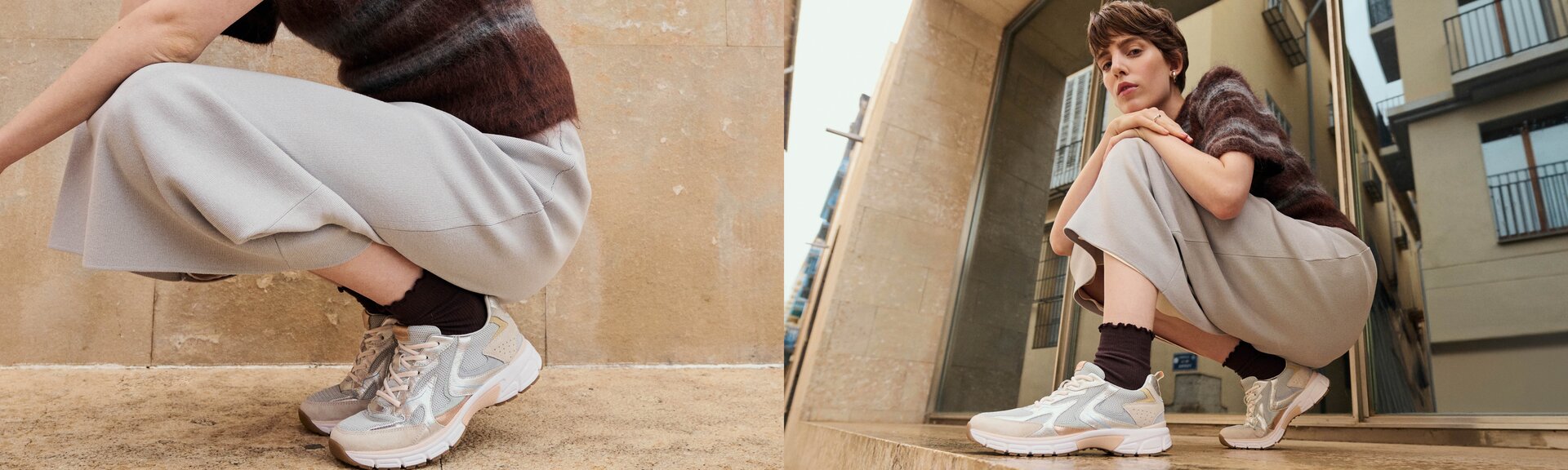 En kvinna sitter hukande utomhus framför byggnader och har ljusa sneakers, mörka strumpor, vida grå byxor och en brun randig tröja på sig. Fokus ligger på skorna. | © Gabor Shoes GmbH, Tyskland