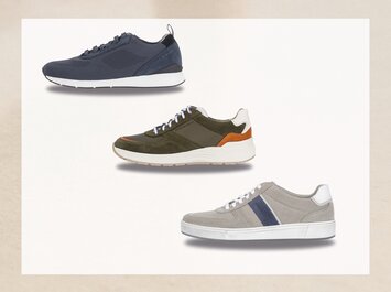 Tre herrsneakers i olika färger – mörkblå, olivgrön med orange och vit samt ljusgrå med blå rand – står under varandra mot en ljus bakgrund. | © Gabor Shoes GmbH, Tyskland